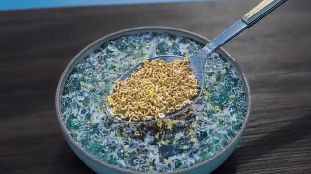 Analogie visuelle d'une cuillère soulevant des lettres dans un bol de soupe à l'alphabet pour expliquer la méthode de l'ADNe.