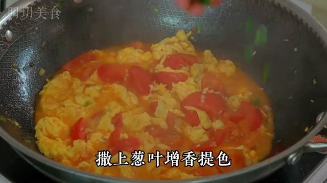 Ajout du mélange d'eau et de fécule dans le wok avec les oeufs et les tomates